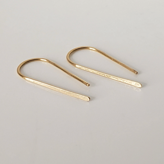 Small 14k gold threader earrings against white background