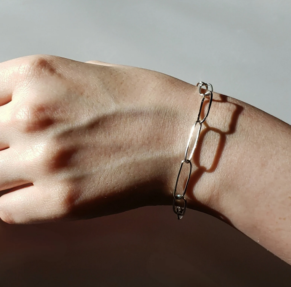 Adjustable silver link bracelet on womans wrist