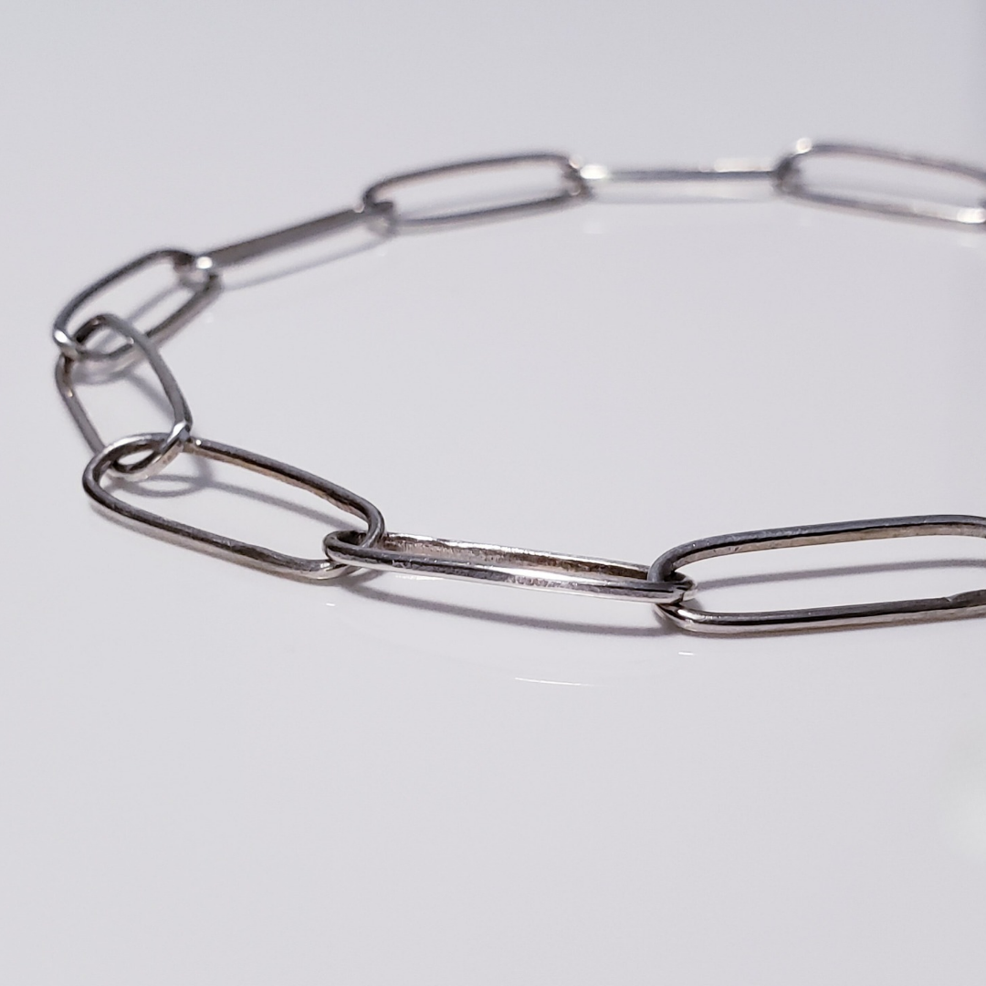 Adjustable silver link bracelet on white background