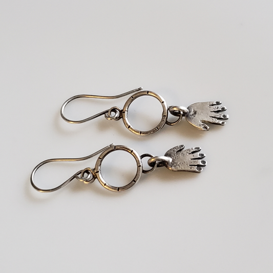 Silver hands on hoop earrings