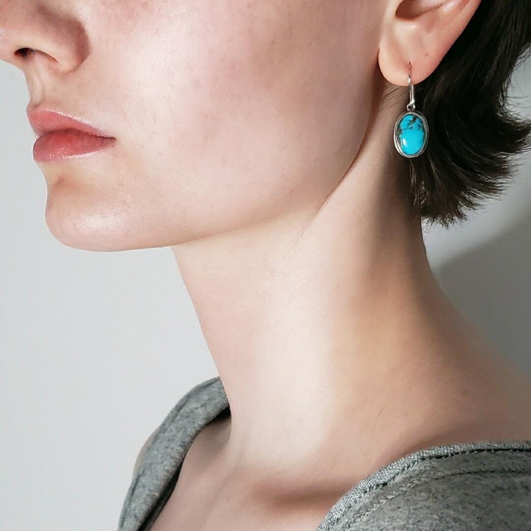 Left facing model wearing blue turquoise earrings