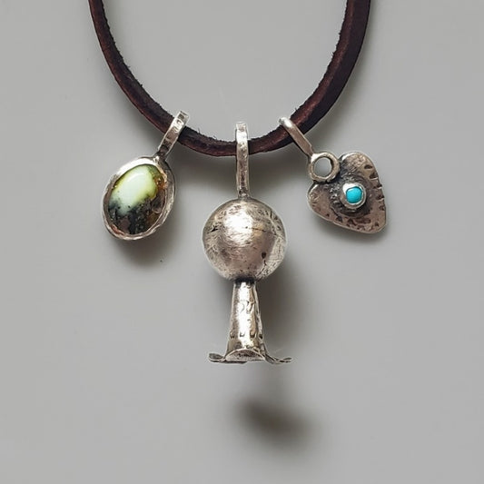 Three sterling silver charms on brown leather necklace