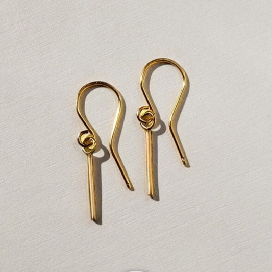 Dainty gold earrings on wires