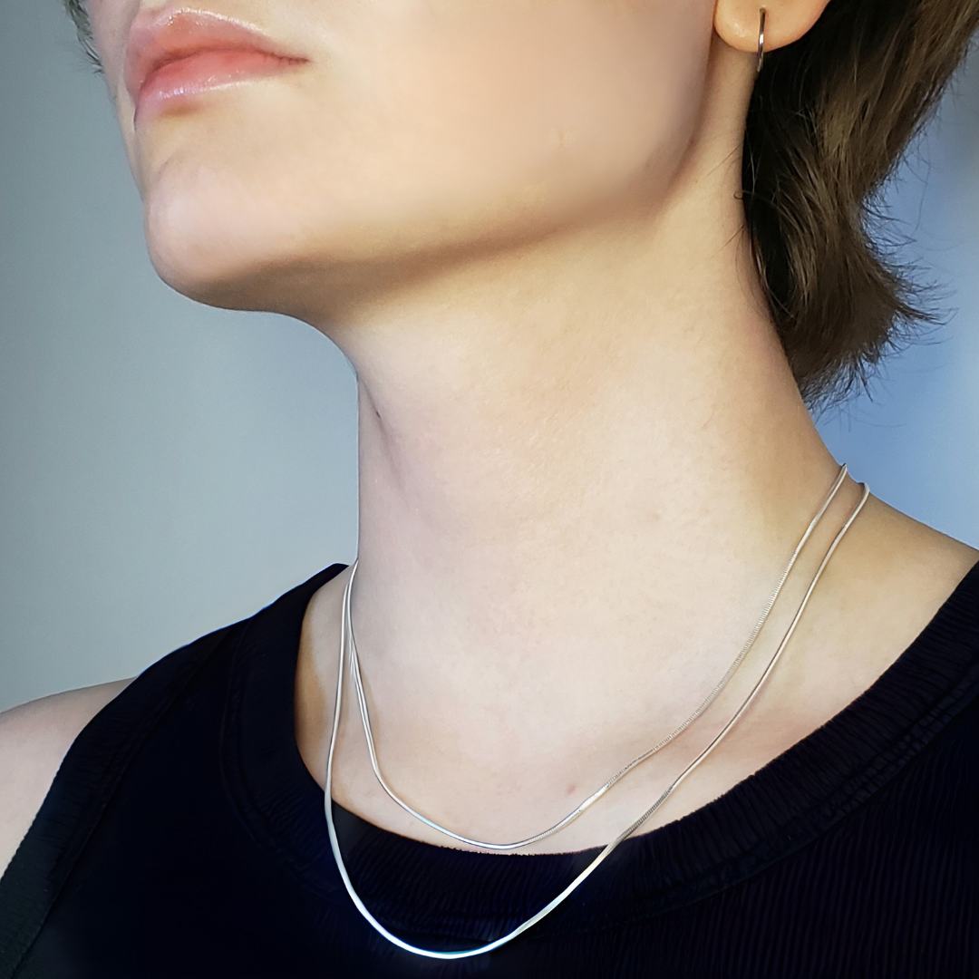 Image of model wearing a silver snake chain necklace