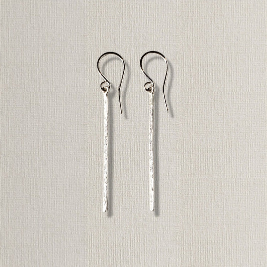 Long silver bar earrings with hammered texture hung on sterling ear wires