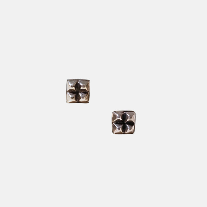 Sterling silver square stud earrings with four raised pyramid facets and post closures
