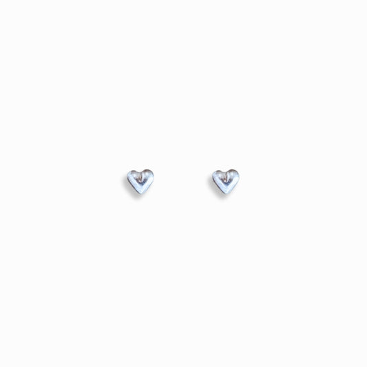 Image of front facing silver heart stud earrings against white background drop