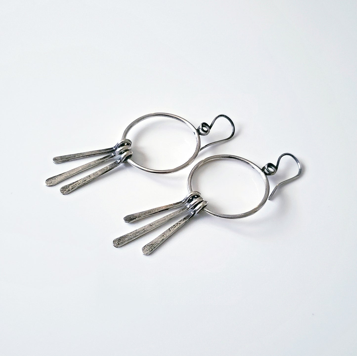 Silver hoop earrings with long dangles