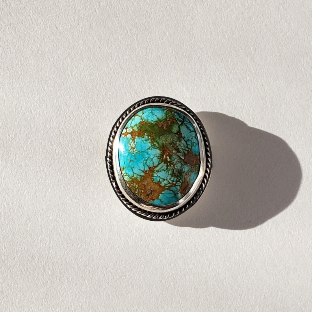 Large turquoise ring against white background 