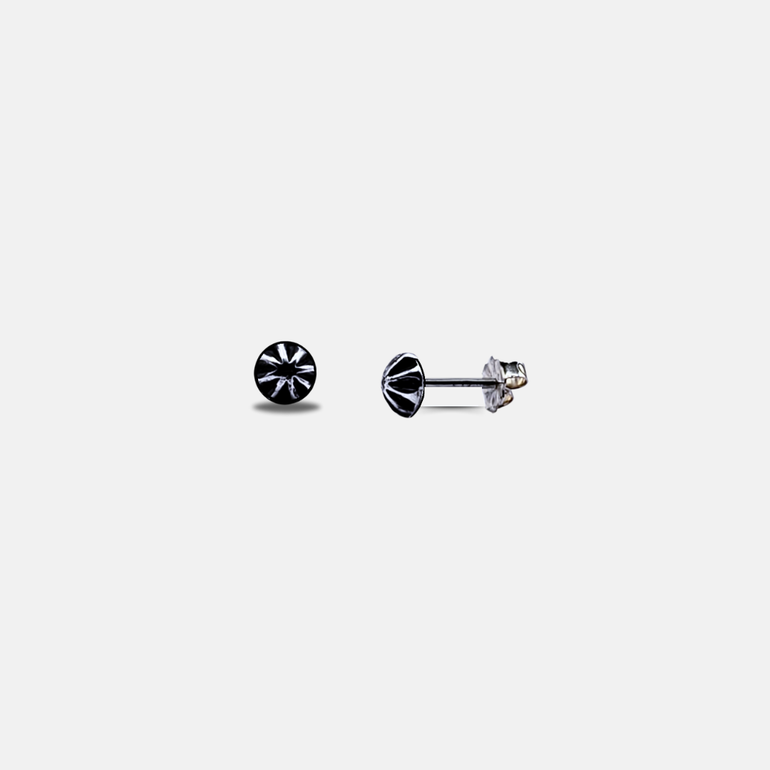 Image of a pair of handcrafted small silver stud earrings against a white background 