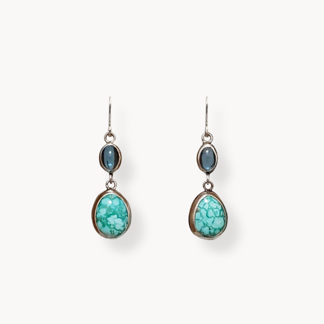 Turquoise and topaz earrings against white background 