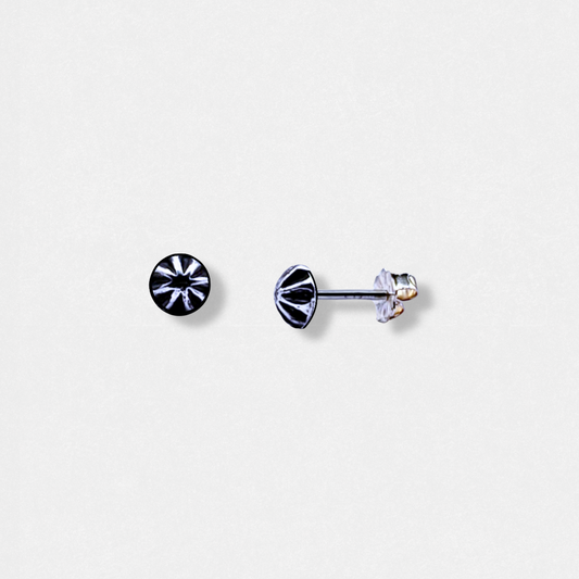 Image of a pair of handcrafted small silver stud earrings against a white background