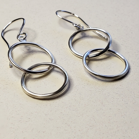 Double hoop earrings on beige background 