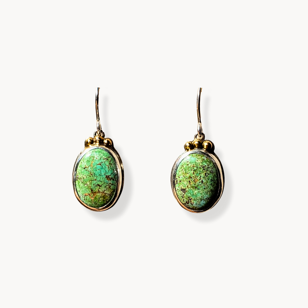 Green turquoise earrings with gold against white background 