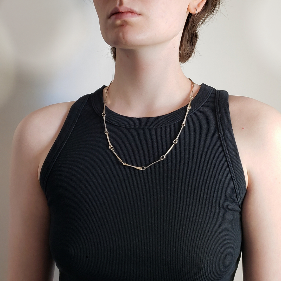 Left facing model wearing heavy handmade sterling silver chain necklace 