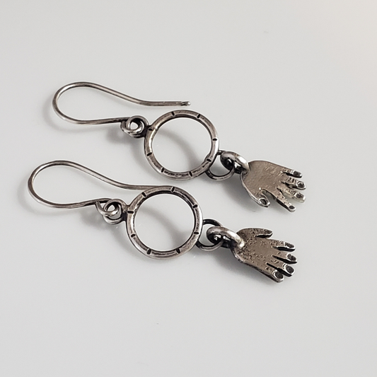 Silver hands on hoop earrings