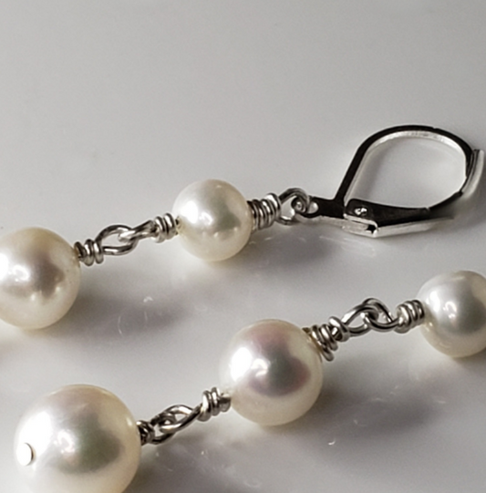 Long pearl earrings with three freshwater pearls, wrapped with sterling silver wire connectors hung from silver latch back closures.