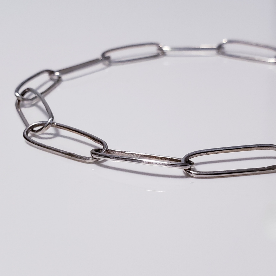 Adjustable silver link bracelet on white background 