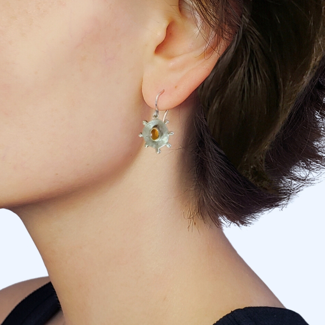 Left facing model wearing silver earrings 