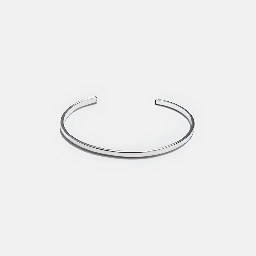 Imagine of a shiny silver stacker bracelet on a white background 