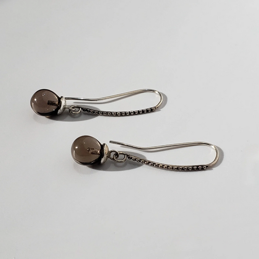Left facing long smokey quartz and sterling silver earrings. 