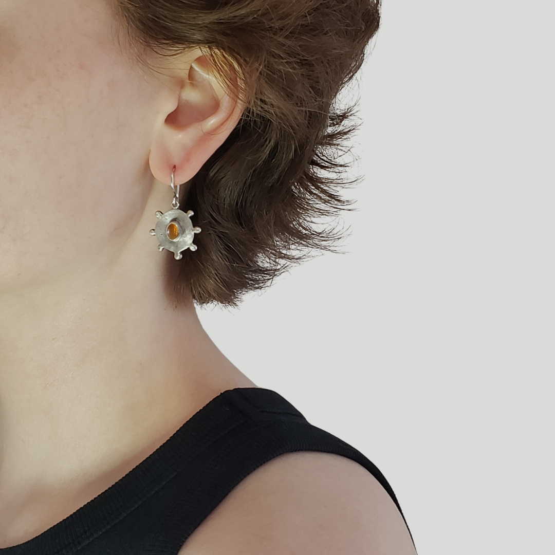 Image of model wearing handmade yellow citrine coin earrings