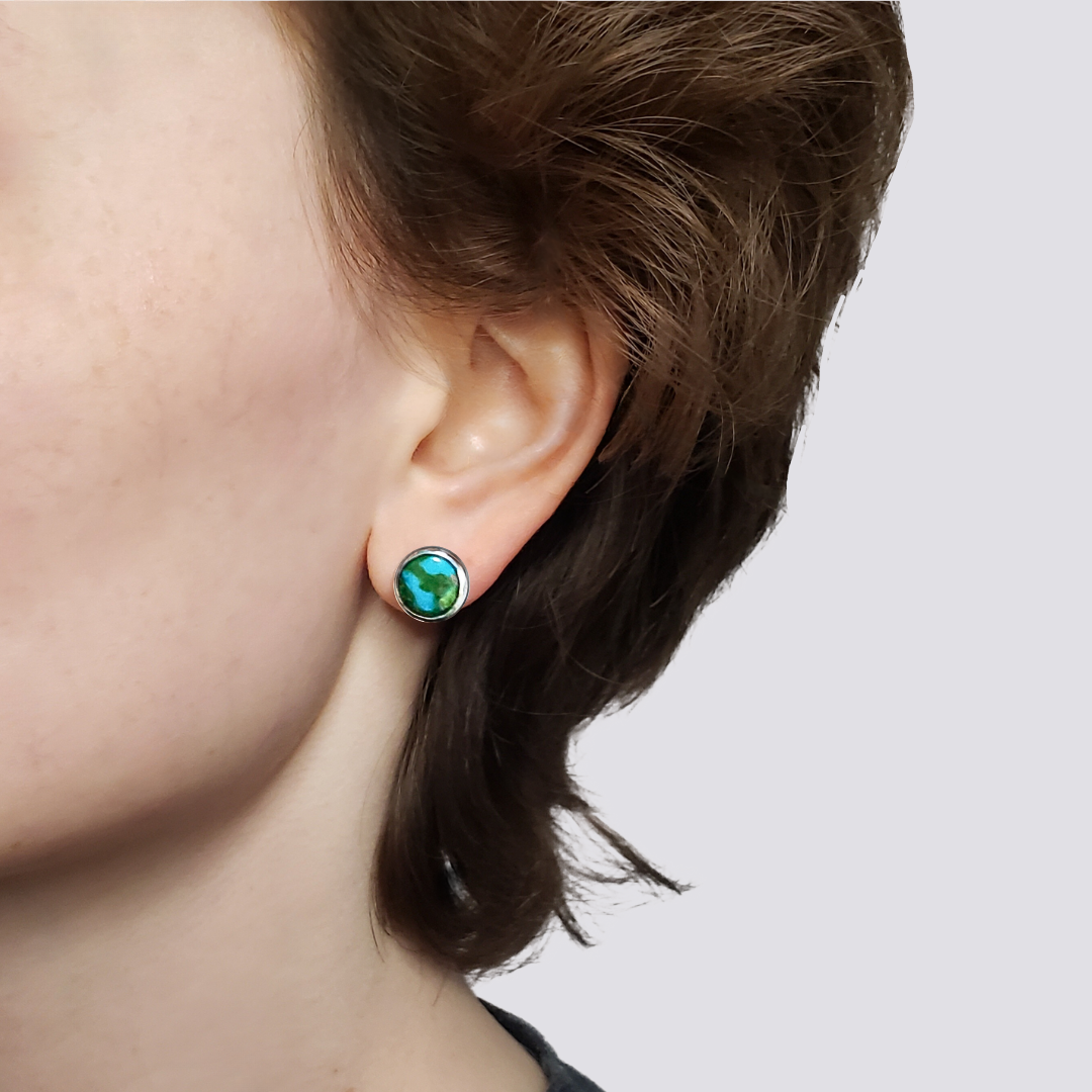 Left facing model wearing handmade turquoise stud earrings 