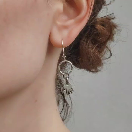 Silver hands on hoop earrings