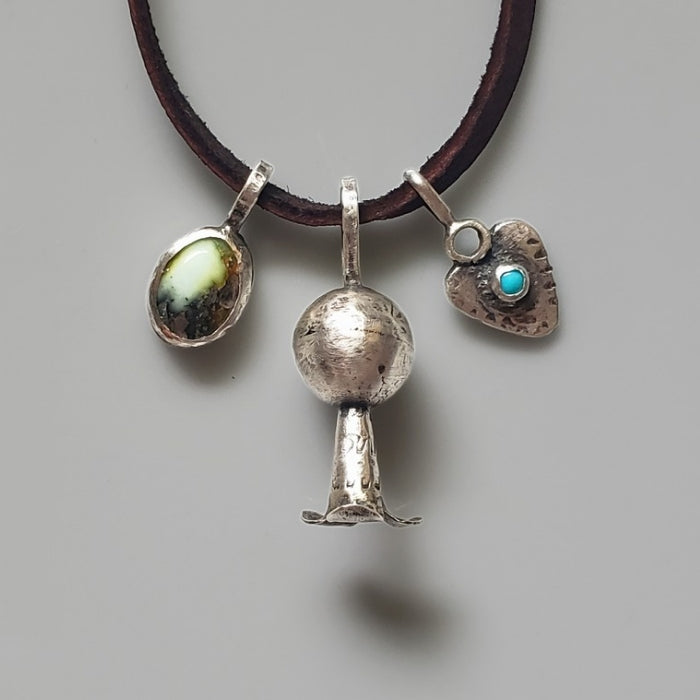 Sterling silver charm necklace on brown cordage