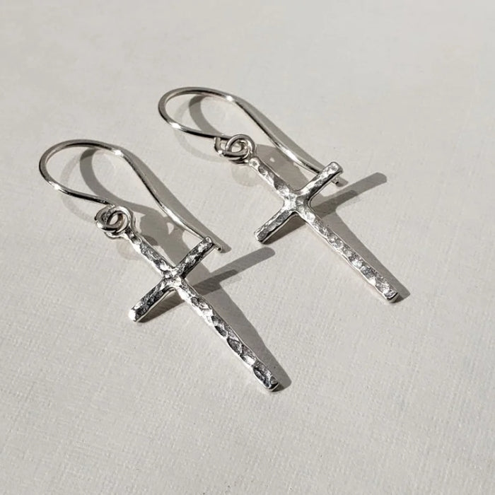 Small hammered silver cross earrings hung on sterling silver wires 
