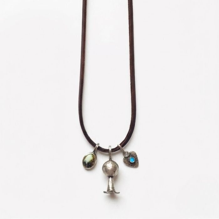 Sterling silver charm necklace on brown cordage