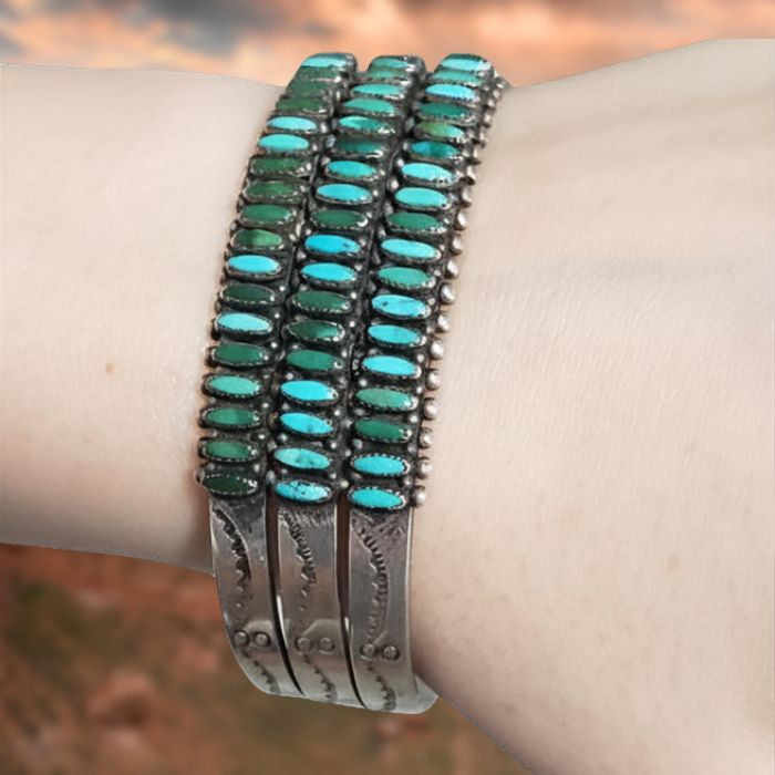 Turquoise beaded bracelet on a wrist with a blurred background