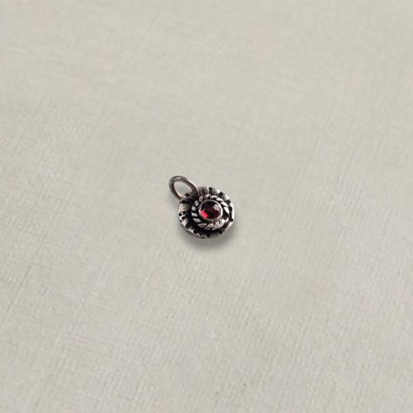 Sterling silver and red garnet charm