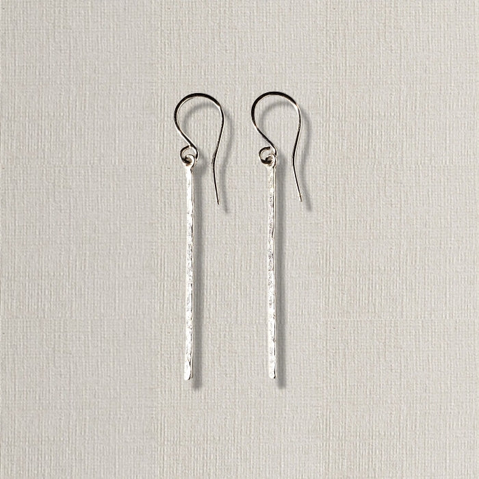 Long silver bar earrings with hammered texture hung on sterling ear wires