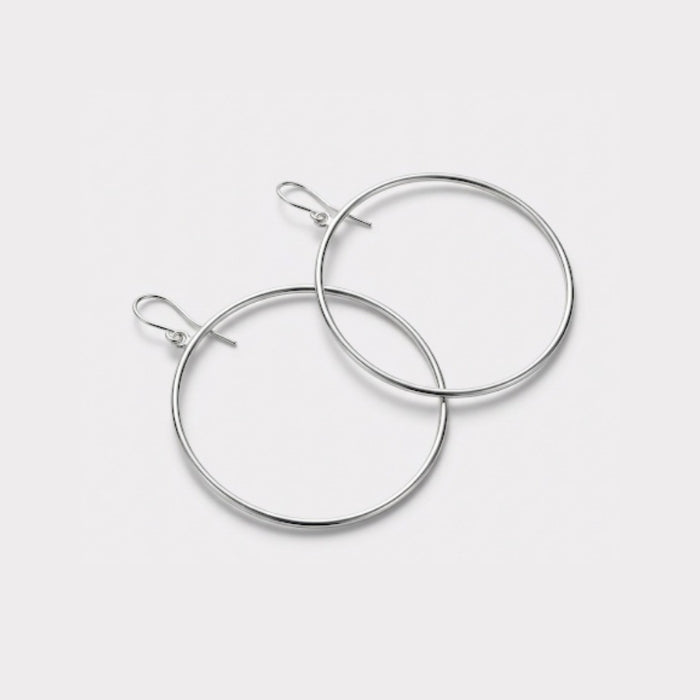 Pair of silver hoop earrings on a light gray background
