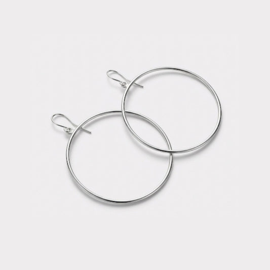 Pair of silver hoop earrings on a light gray background
