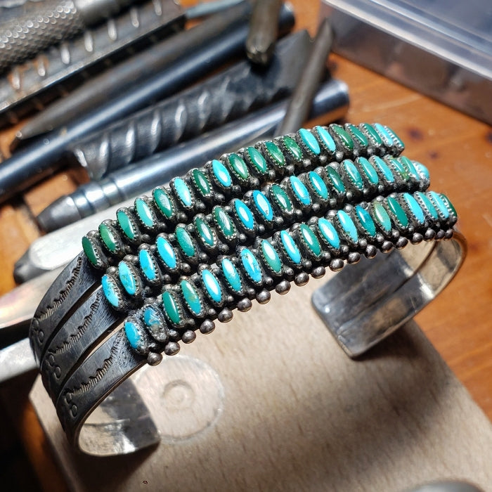 Bracelet with turquoise stones on a wooden surface