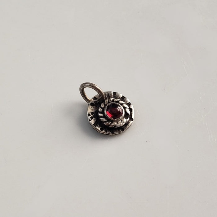 Sterling silver and red garnet charm