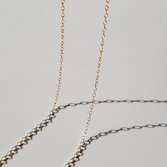 Large link gold chain against white background 