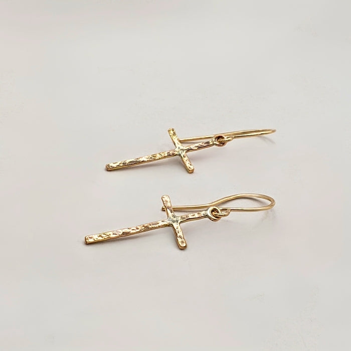 Gold cross earrings with subtle hammered texture finish hung on artisan wires