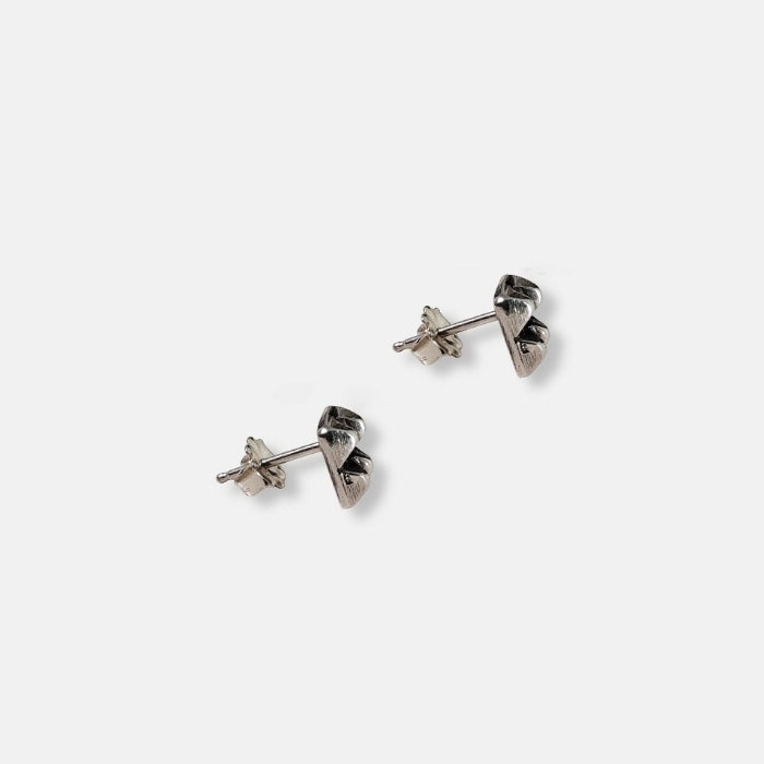 Sterling silver square stud earrings with four raised pyramid facets and post closures