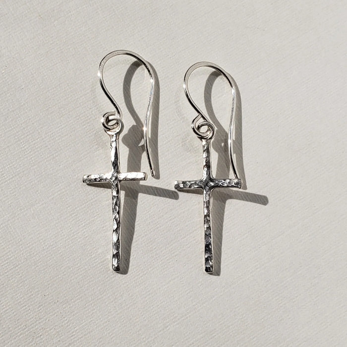 Small hammered silver cross earrings hung on sterling silver wires 