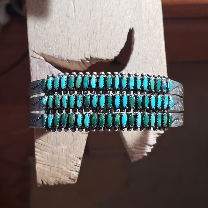 Turquoise beaded bracelet on a wooden surface