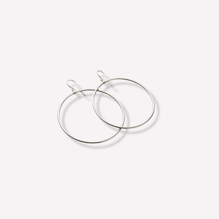 Pair of silver hoop earrings on a white background